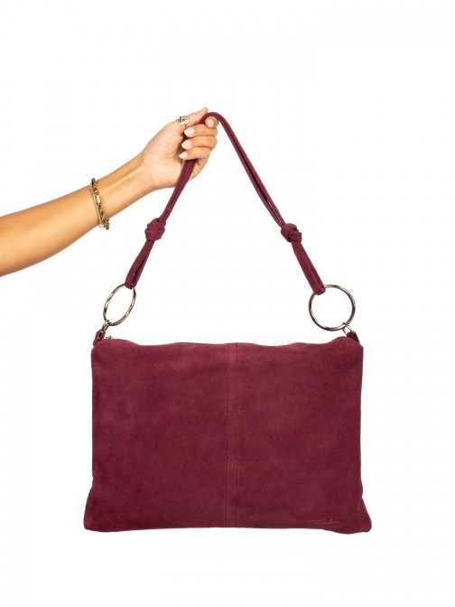 Suede shoulder bag with metal rings.